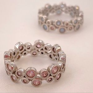 Sterling silver ‘circle’ band with clear pink/blue cubic zirconia. Size 9.5.